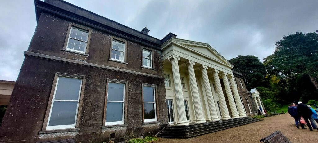 front of a grand house with columns
